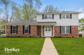 Saint Peters house for rent - A brick house with a white door and a small porch.
