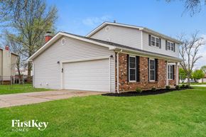 Saint Peters house for rent - A house with a garage and a brick chimney is for sale.
