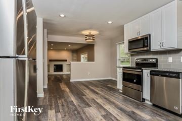 Saint Peters house for rent - A kitchen with a stainless steel refrigerator and wooden floors.