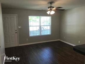 Concord house for rent - A room with a wooden floor and a ceiling fan.