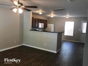 Concord house for rent - A kitchen area with a fan and wooden floors.