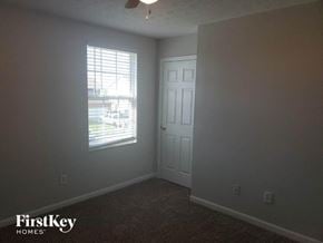 Monroe house for rent - a bedroom with a window and a white door