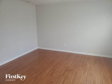 Monroe house for rent - the living room with wood floors and white walls