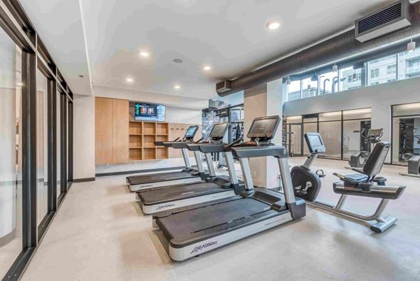 Calgary apartment for rent - A gym with treadmills and weight machines.