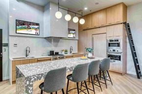 Calgary apartment for rent - A modern kitchen with a dining table set for four.