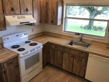 Bradenton house for rent - a kitchen with a stove sink and a window