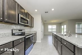 Saint Cloud house for rent - a modern kitchen with stainless steel appliances and granite counter tops