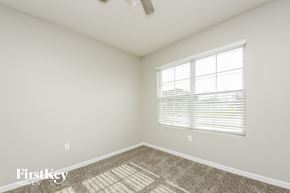Saint Cloud house for rent - a bedroom with a large window and a carpet