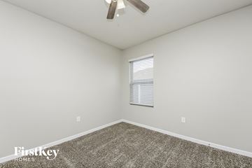 Saint Cloud house for rent - the spacious living room has carpet and a ceiling fan