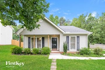 Greensboro house for rent - a small white house with a sidewalk in front of it