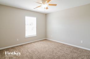 Summerville house for rent - a bedroom with carpet and a ceiling fan