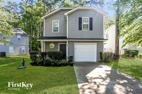 Charlotte house for rent - a gray house with a white garage door and a lawn