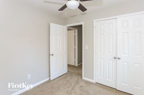 Charlotte house for rent - a bedroom with three closets and a ceiling fan