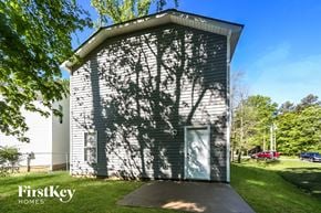 Charlotte house for rent - the shadow of a tree on the side of a small building