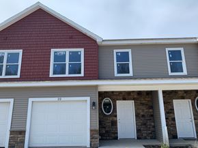Penn Yan apartment for rent - the front of a house with two garage doors