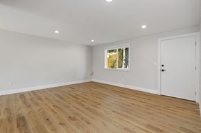 Bothell apartment for rent - a living room with white walls and wooden floors and a window