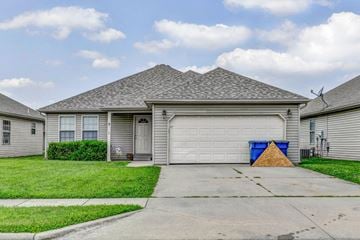 Springfield house for rent - a white house with a garage door and a driveway