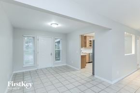 Orange Park house for rent - A white interior of a house with a kitchen in the background.