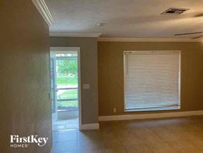 Cape Coral house for rent - an empty living room with a window and a door