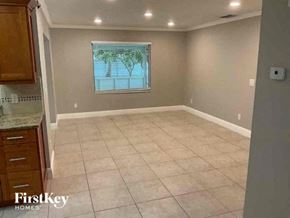 Cape Coral house for rent - a empty room with a window and a tiled floor