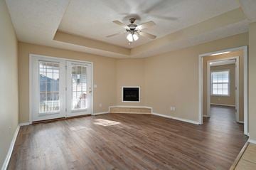 Springfield house for rent - A spacious living room with a television and sliding glass doors.