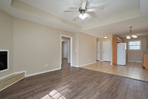 Springfield house for rent - A spacious living room with a fireplace and hardwood floors.