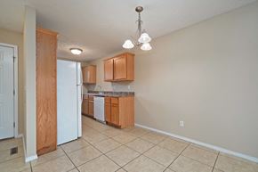 Springfield house for rent - A kitchen with wooden cabinets and a white refrigerator.