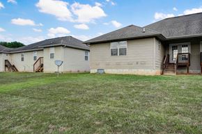 Springfield house for rent - A grassy field with two houses in the background.