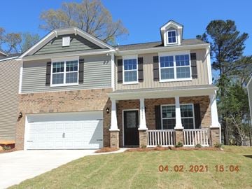 Charlotte house for rent - a front view of a house with a white garage door