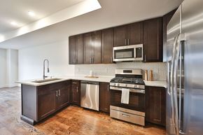 Philadelphia apartment for rent - a kitchen with dark wood cabinets and stainless steel appliances