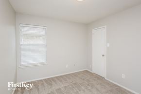 Fort Worth house for rent - a bedroom with white walls and carpet and a white door