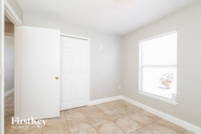 Kissimmee house for rent - a bedroom with a door and a window and a tiled floor