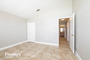 Kissimmee house for rent - the living room and hallway of a home with white walls and tile flooring