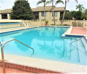 Bradenton house for rent - a large swimming pool with a house in the background
