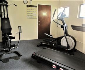 Bradenton house for rent - a gym with exercise equipment in a room with a door