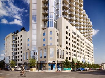 Austin apartment for rent - A tall building with many windows and balconies is in the background.