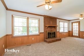 High Point house for rent - a living room with a brick fireplace and a ceiling fan