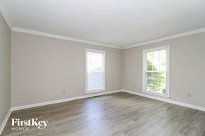 High Point house for rent - the living room of a house with wooden floors and white walls