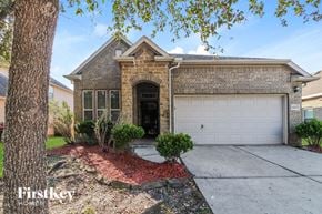 Baytown house for rent - A house with a garage and a driveway in front of it.