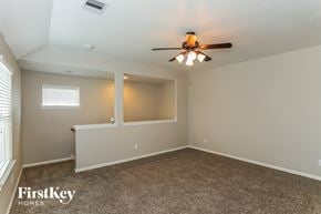 Baytown house for rent - A room with a ceiling fan and a window with blinds.