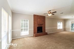 Marietta house for rent - a living room with a brick fireplace and a ceiling fan