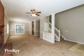 Marietta house for rent - an empty living room with stairs and a ceiling fan