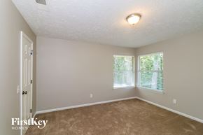 Marietta house for rent - a bedroom with a carpeted floor and two windows