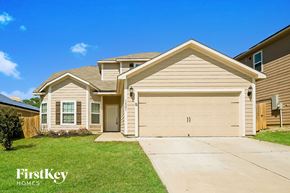 Dallas house for rent - a beige and brown house with a garage door