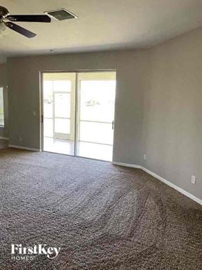 Cape Coral house for rent - A room with a carpeted floor and a ceiling fan.