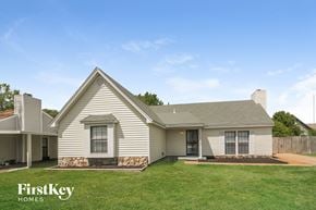 Memphis house for rent - A house with a stone wall in front of it.