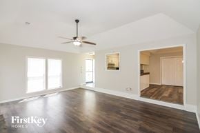 Memphis house for rent - A spacious room with a ceiling fan and wooden flooring.