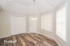 Memphis house for rent - A room with wooden floors and a chandelier hanging from the ceiling.