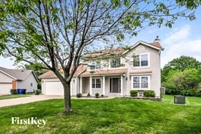 Saint Peters house for rent - a white house with a large tree in the yard