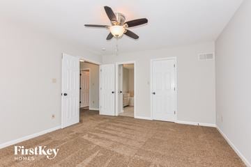 Saint Peters house for rent - a living room with carpet and a ceiling fan